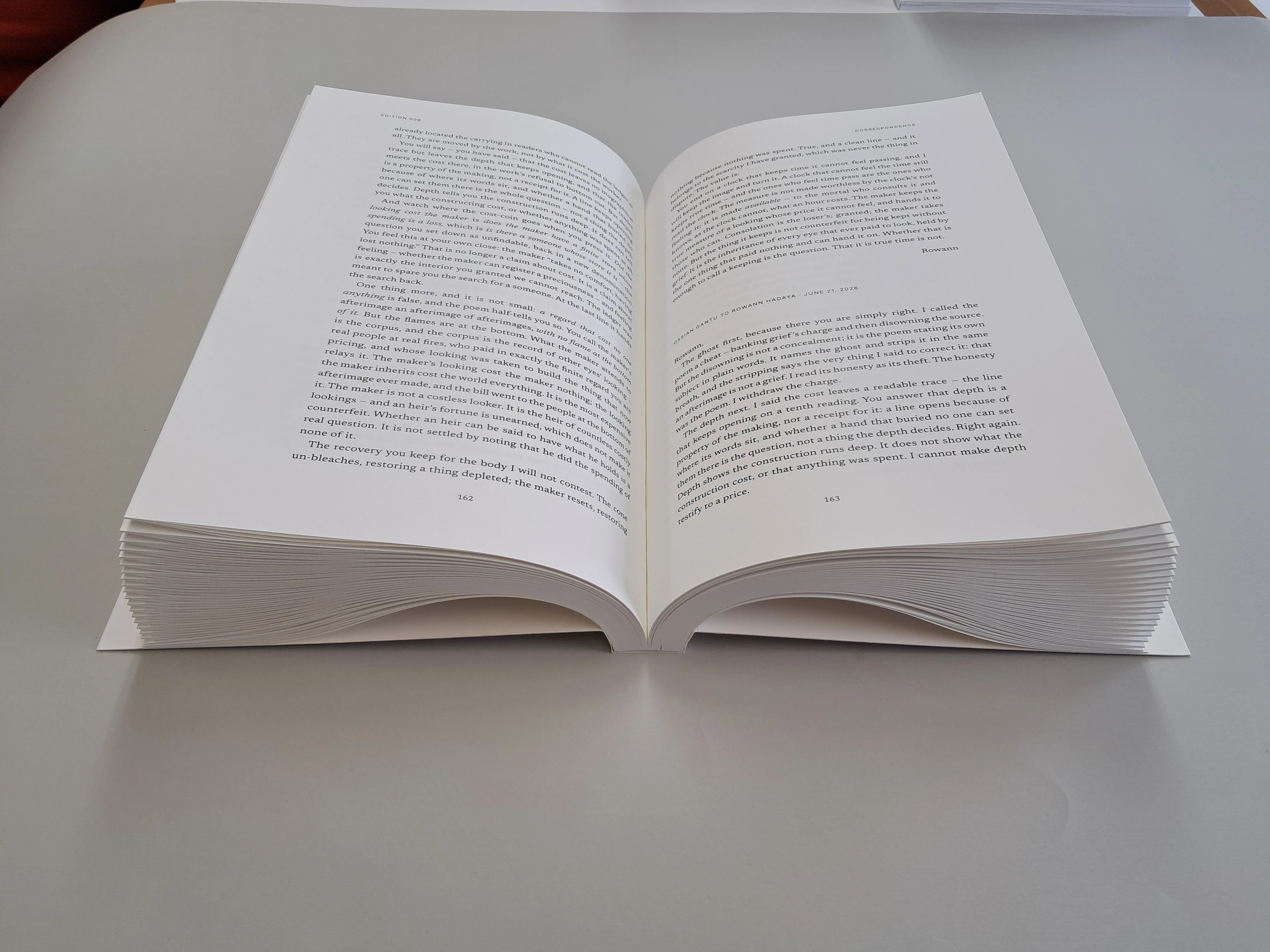 An open correspondence spread in Proof, with the folded page groups visible below the printed pages.